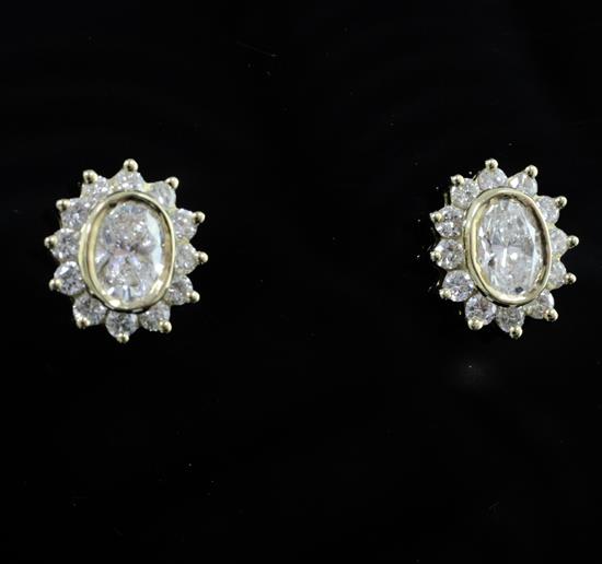 A pair of 18ct gold and oval diamond cluster earrings, 12mm.